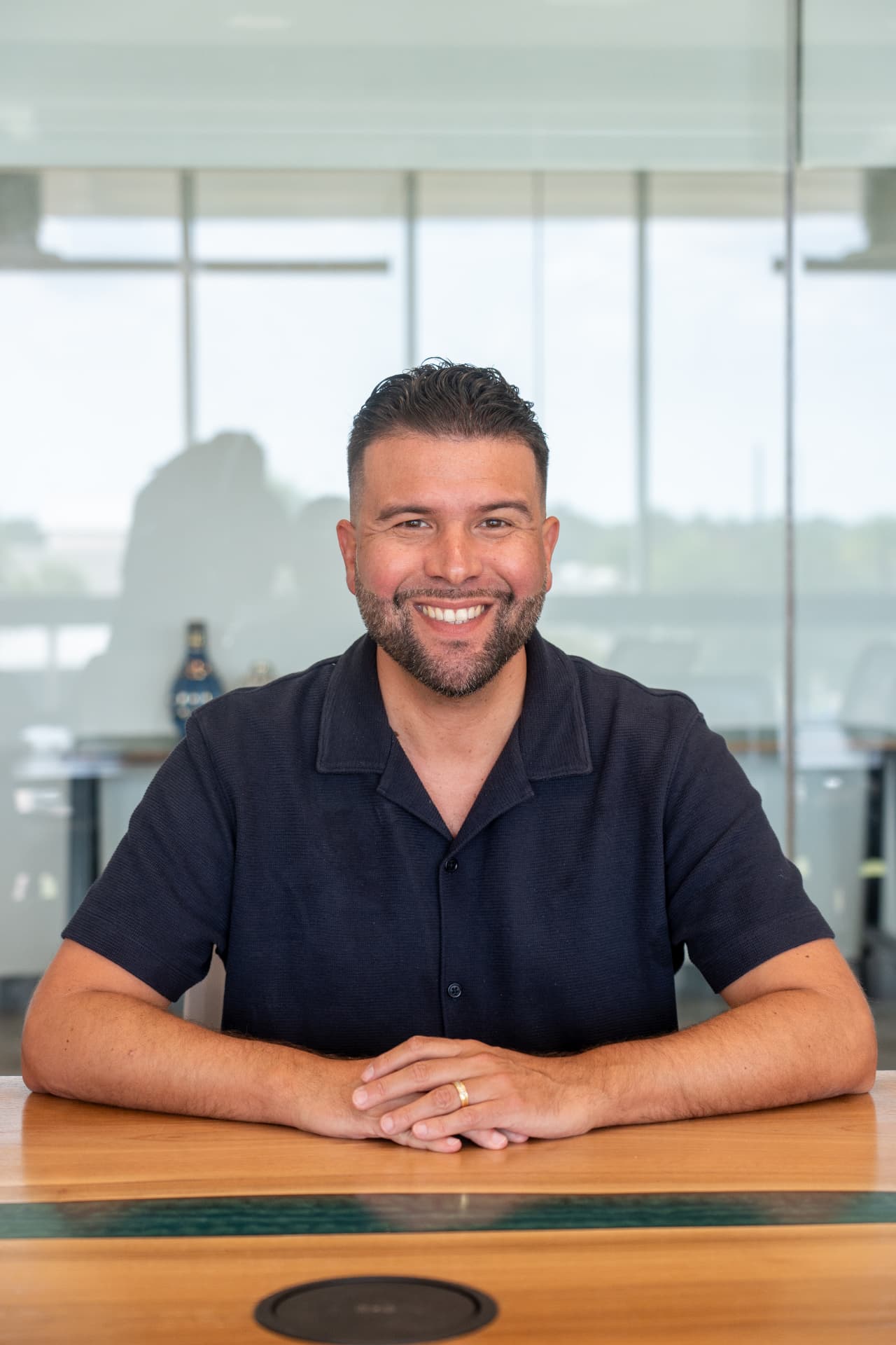 Carlos Gil, Chief Rage Architect, seated at a table.